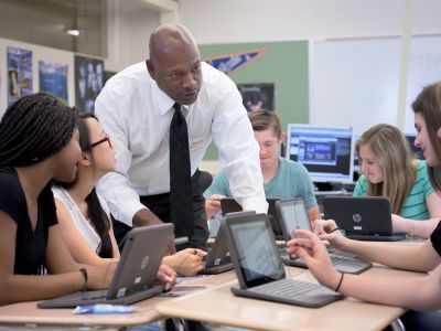 A volunteer working with students